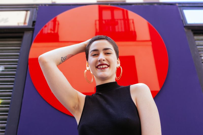 Androgynous woman posing and smiling