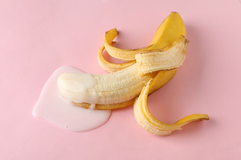 Banana with liquid showing ejaculation concept