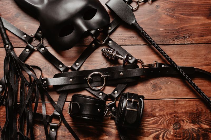 Bondage and fetish gear on table