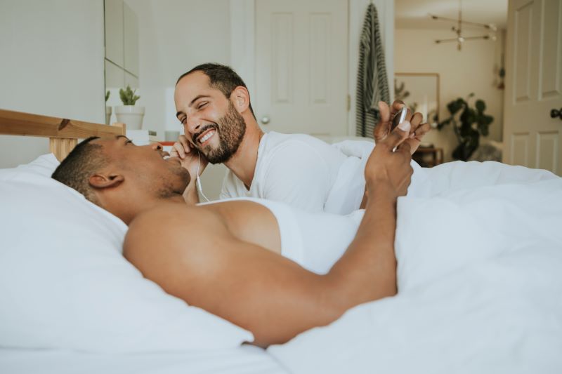 Couple chatting and smiling in bed