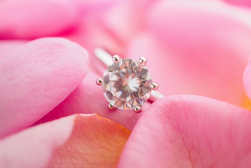 Diamond ring in pink rose petals