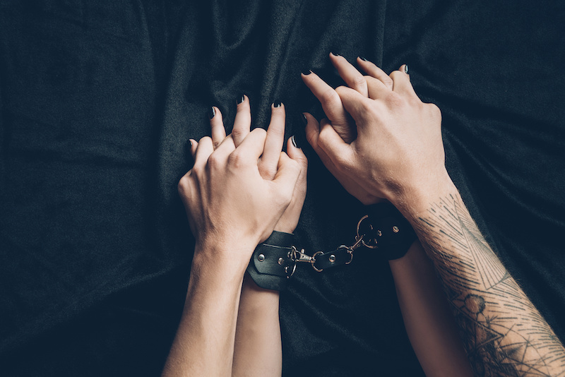 Hands of a couple in handcuffs