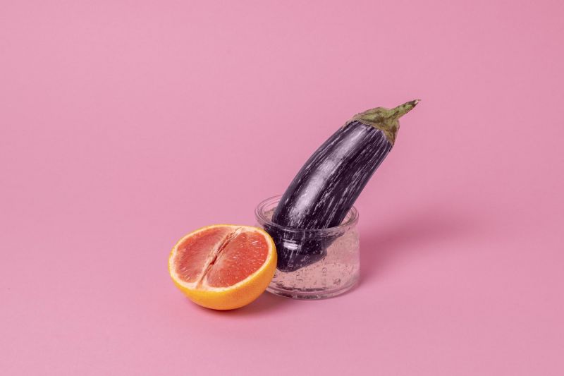 Abstract sexual health arrangement with aubergine grapefruit