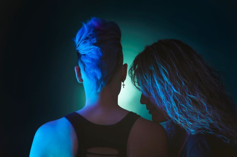 Back view of alternative couple with dramatic lighting