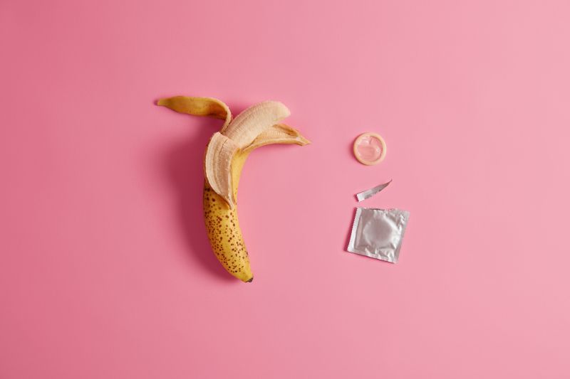 Banana empty condom package contraception concept