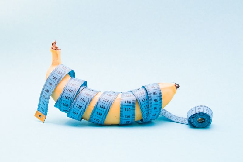 Banana wrapped in blue measuring tape