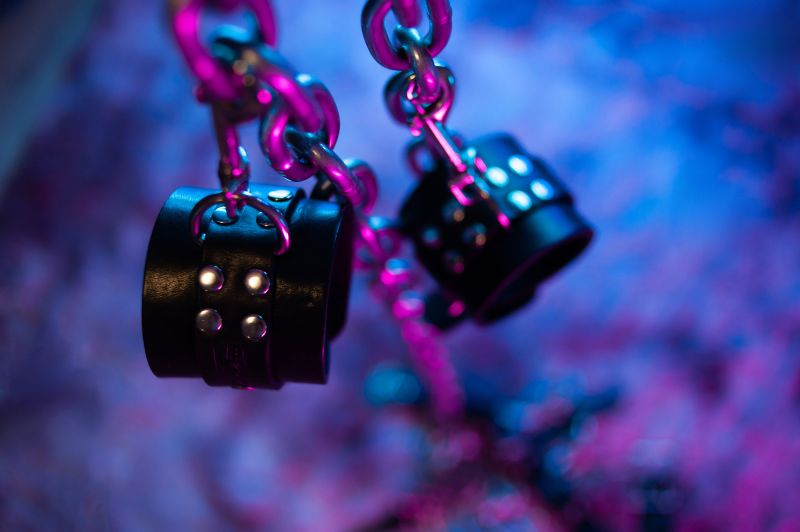 BDSM handcuffs and chains in neon light