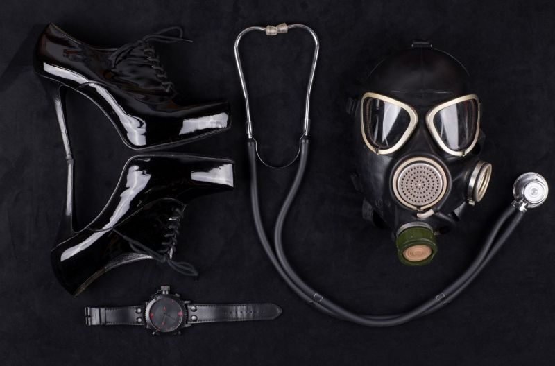 Bondage fetish items on black surface