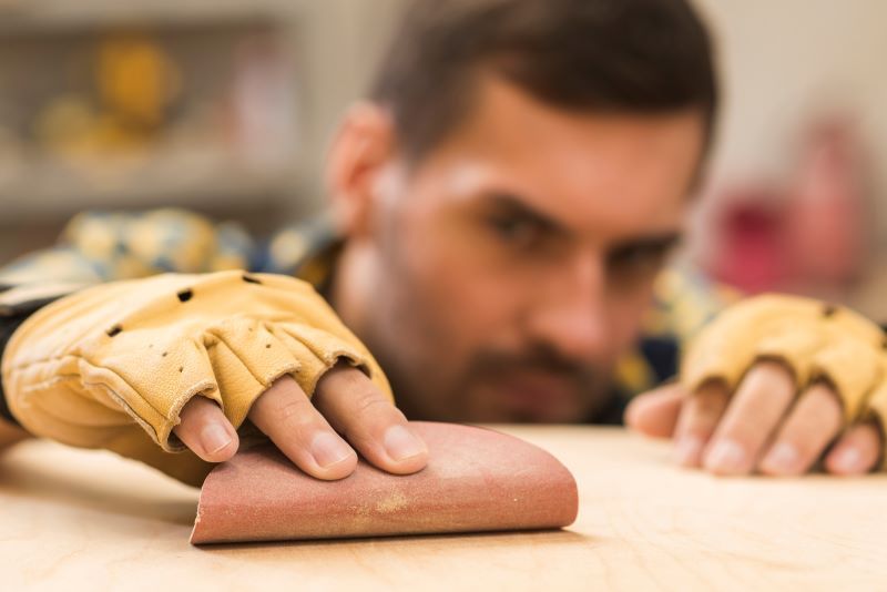 Carpenter with sandpaper