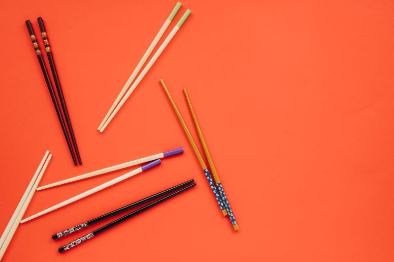 Chopsticks on red background