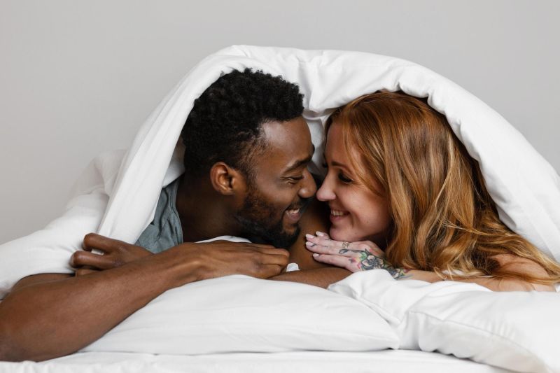 Smiling couple in bed