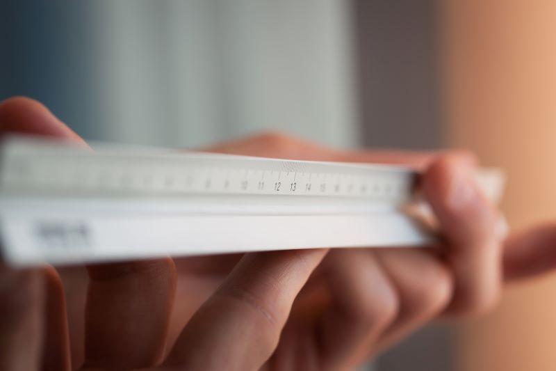 Close up hands holding ruler