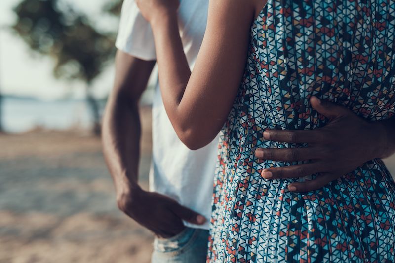 Close up of couple embracing on the beach