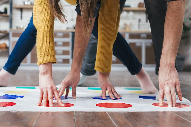 Close up of a couple playing Twister at home