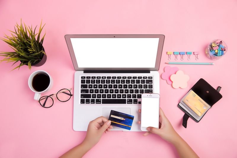 Close up hands over laptop on desk making online payment