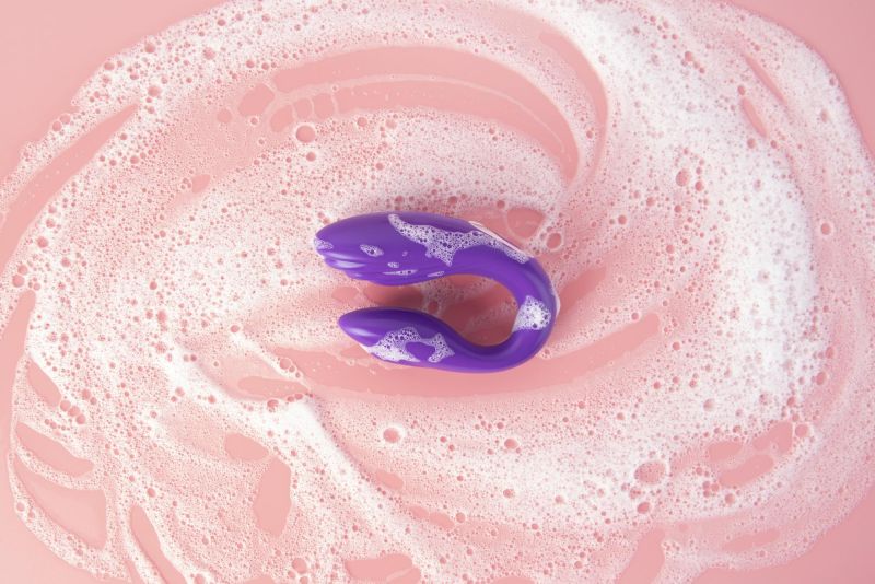 Close up sex toy being washed with foam