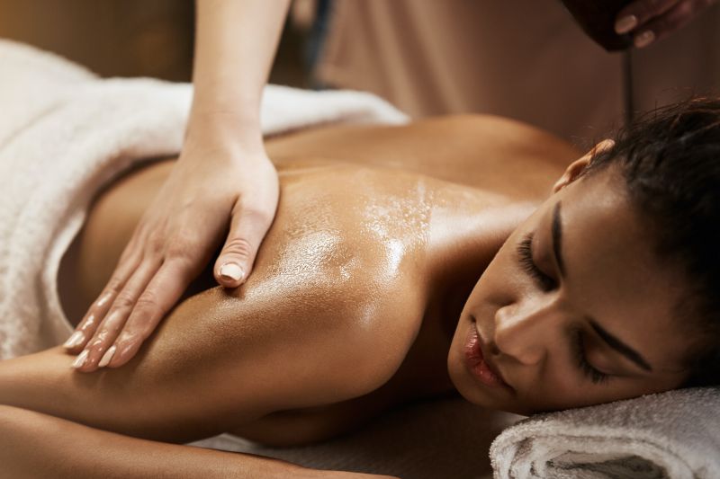 Close up woman getting shoulder massage in white towel