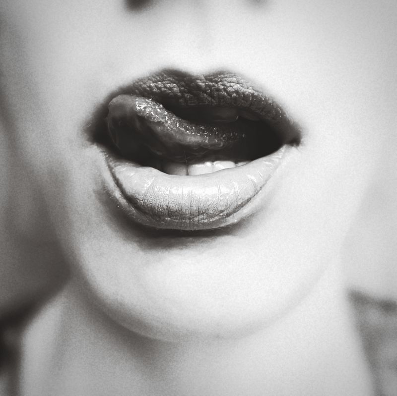 Close up woman licking her lips black and white