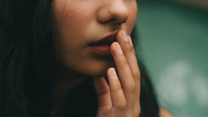 Close up woman touching her lip