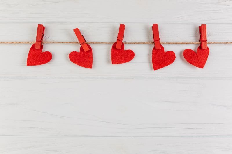 Clothespins holding love hearts