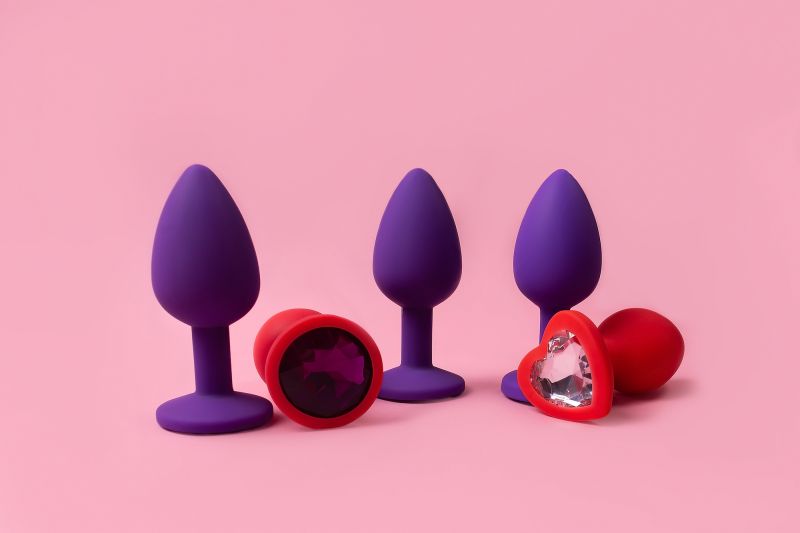 Colourful butt plugs on pink background