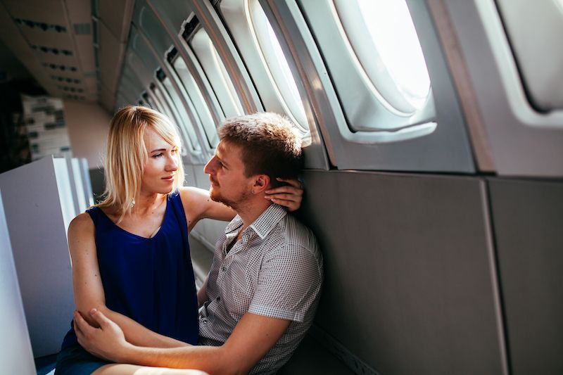 Couple embracing on plane