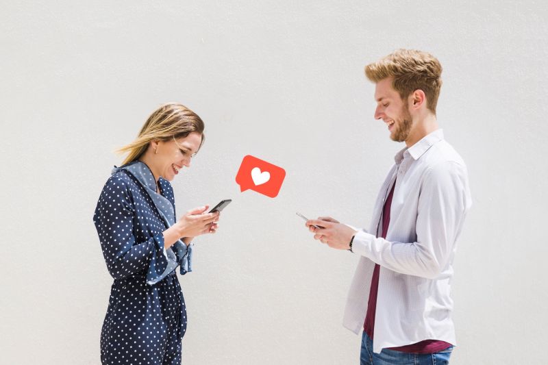 Couple exchanging messages on mobiles