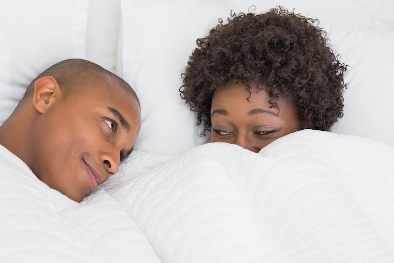 Couple in bed flirty and romantic