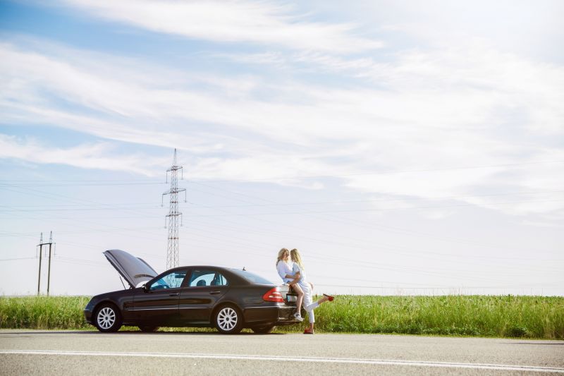 Couple kiss against car