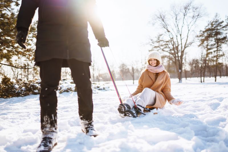 Couple sledding in the snow