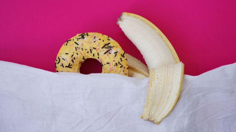 Donut and banana showing sex concept