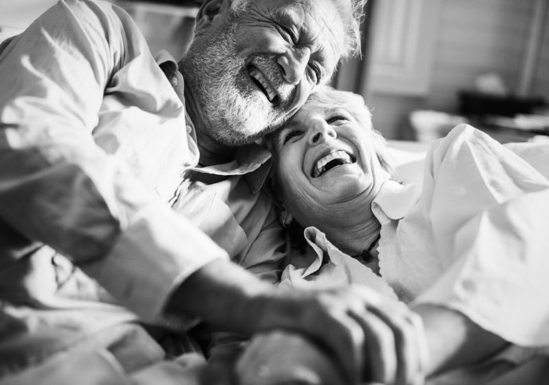 Elder couple laughing and hugging