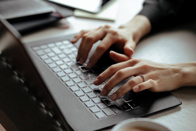 Female hands on laptop keyboard