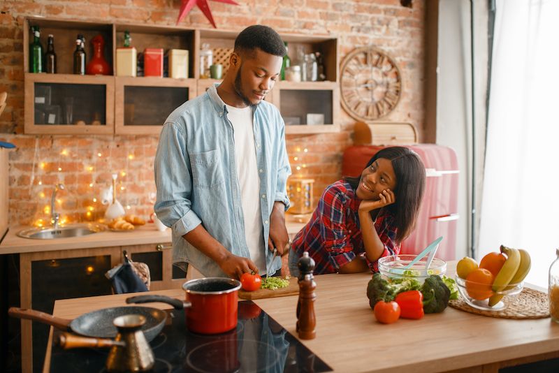 Festive couple cooking at home