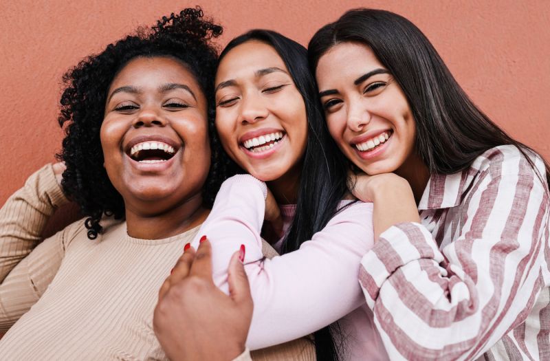 Female friends hugging and smiling