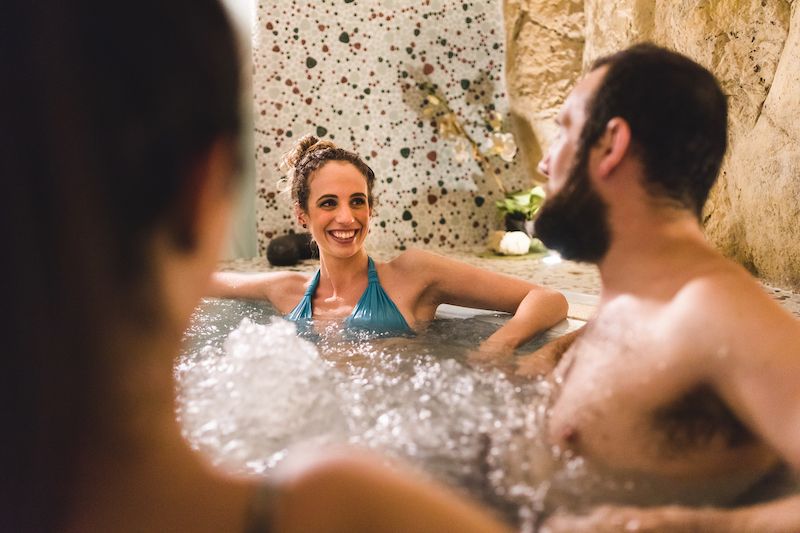 Friends smiling and relaxing in hot tub