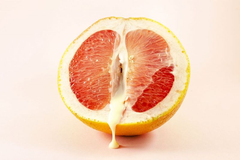 Grapefruit with liquid showing orgasm concept