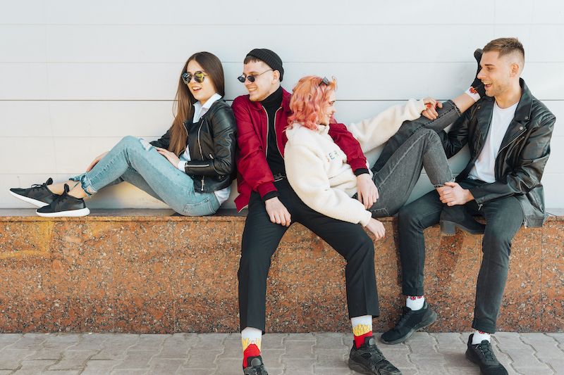 Group of friends relaxing and having fun on bench