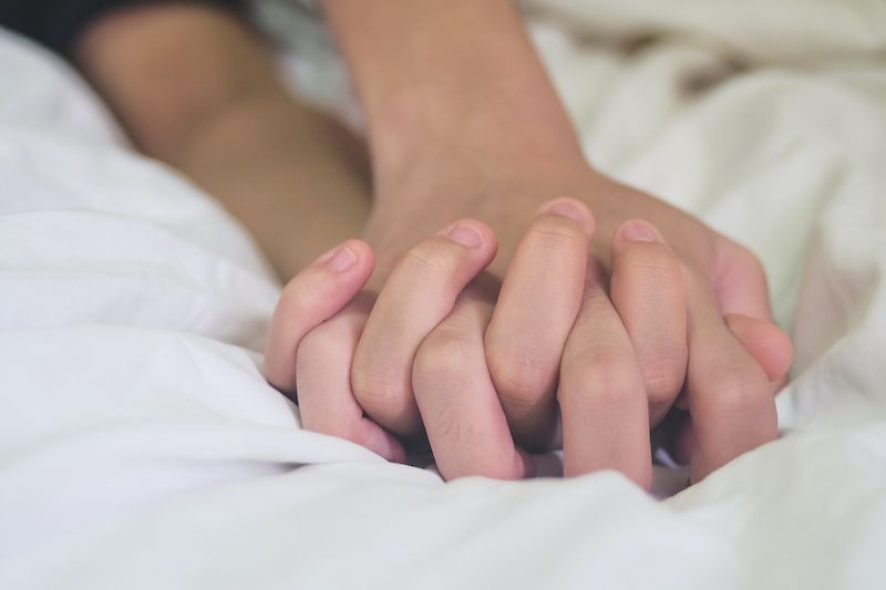 Holding hands on bed sexy