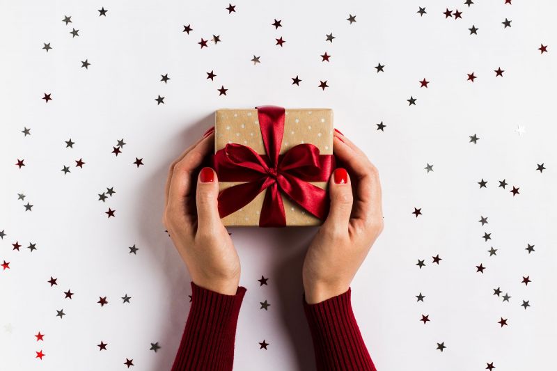 Hands of woman holding Christmas gift