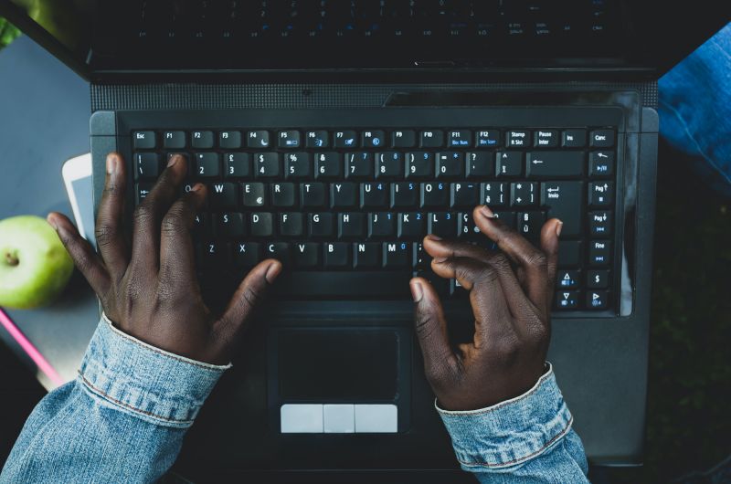 Woman's hands typing on laptop