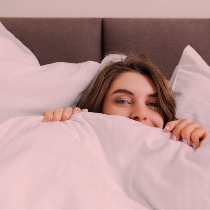 Woman hiding in bed