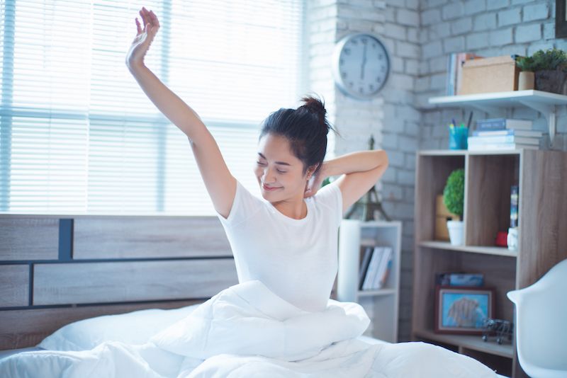 Happy woman waking up