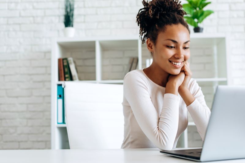 Femme heureuse sur ordinateur portable