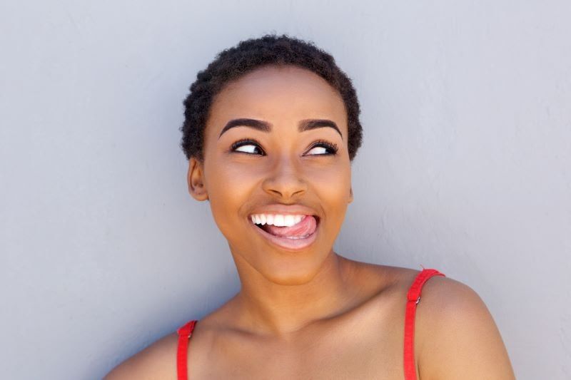 Young happy woman sticking her tongue out