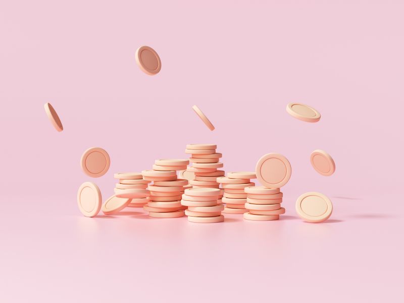 Stack of coins falling on pink background