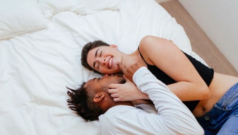 Laughing lovers in bed