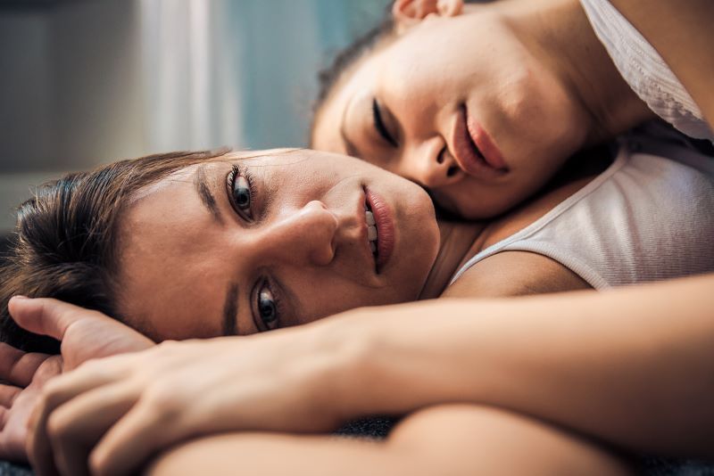 Lesbian couple at home embracing