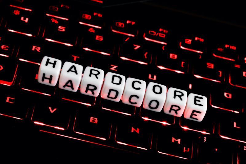 Lettering spelling out hardcore on dark keyboard