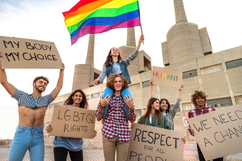 LGBTQ pride protestors holding signs at march